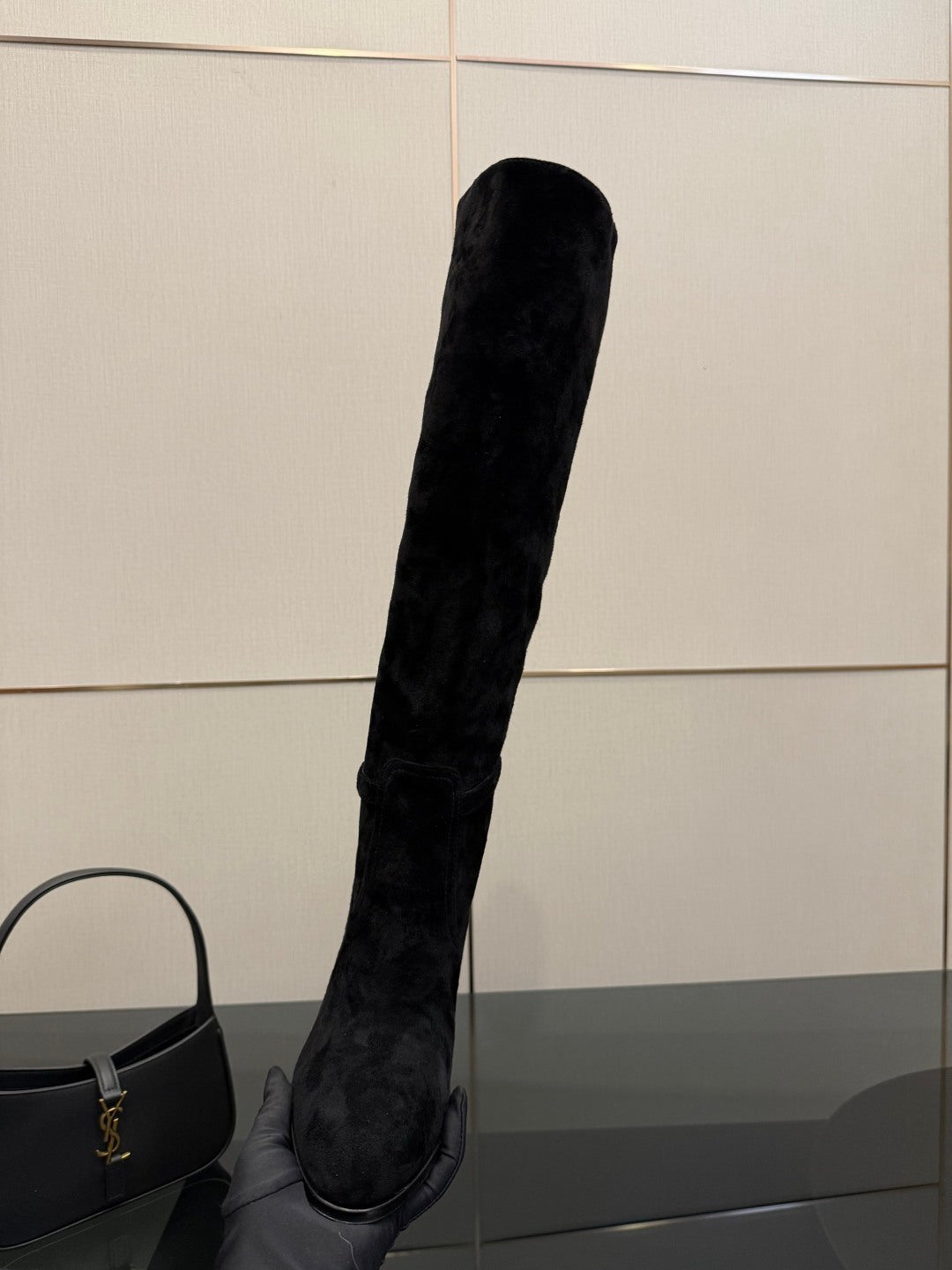 YSL ladies black tall heeled boots, side view of one boot with pointed toe