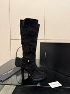 YSL ladies black tall heeled boot, single boot front view with gold buckle