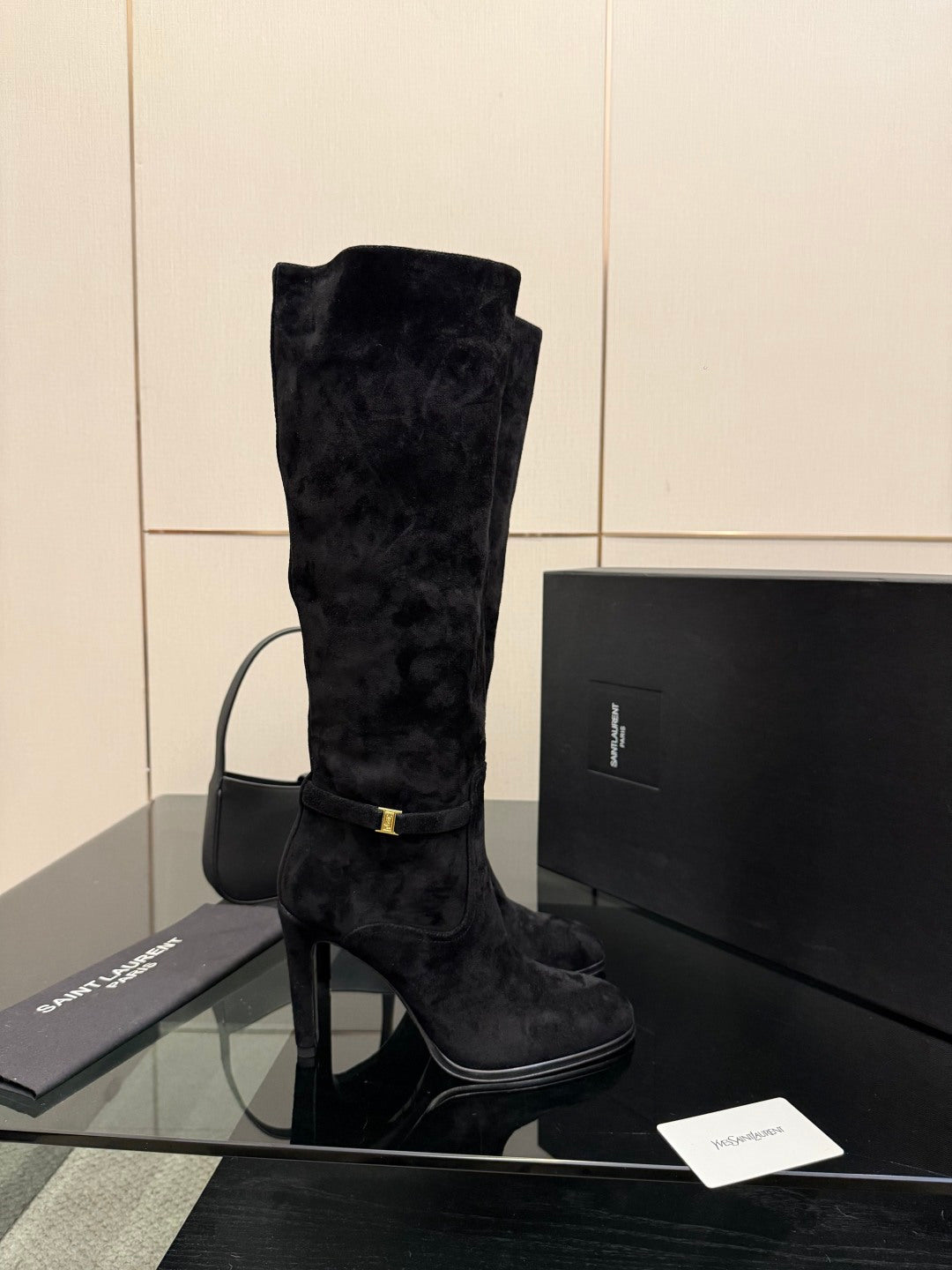 YSL ladies black tall heeled boot, single boot front view with gold buckle
