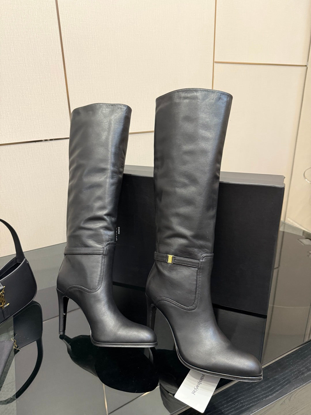 YSL ladies knee-high black leather boots, pair view with gold buckle