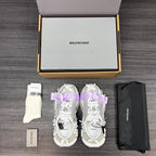 Balenciaga sandals pair in white with lilac ribbon bows, side view with chunky sole