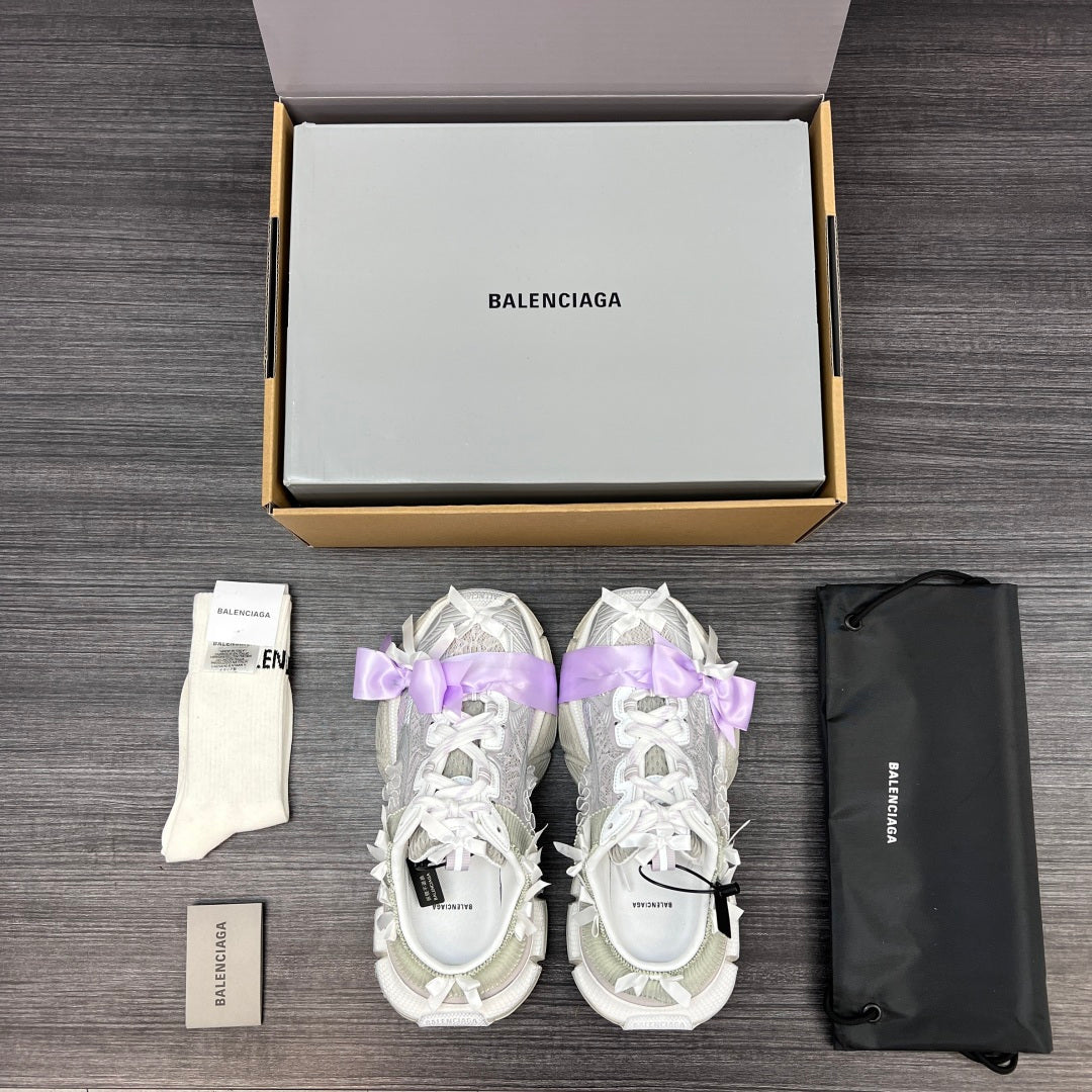 Balenciaga sandals pair in white with lilac ribbon bows, side view with chunky sole