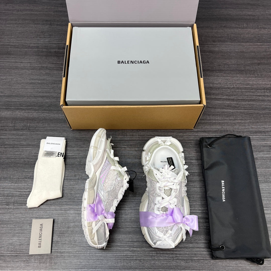 Balenciaga sandals in white with lilac ribbon bows, one pair side profile