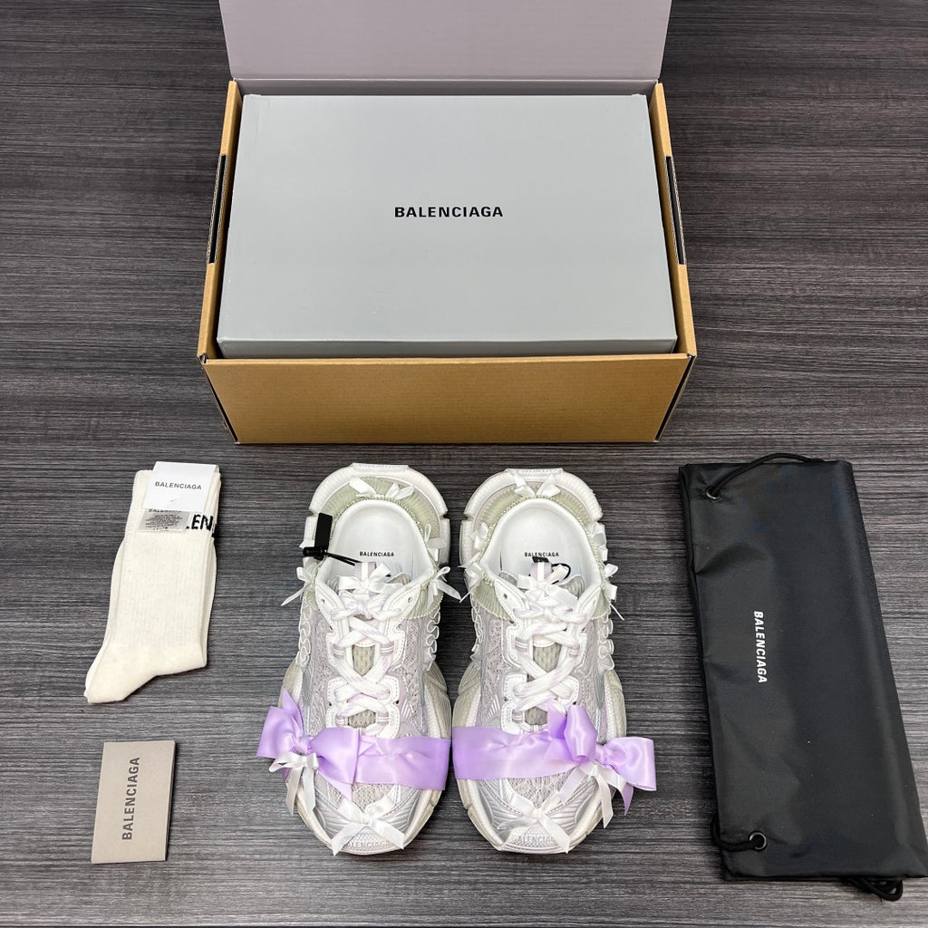 Balenciaga sandals pair in white with lilac ribbon bows and lace-up straps
