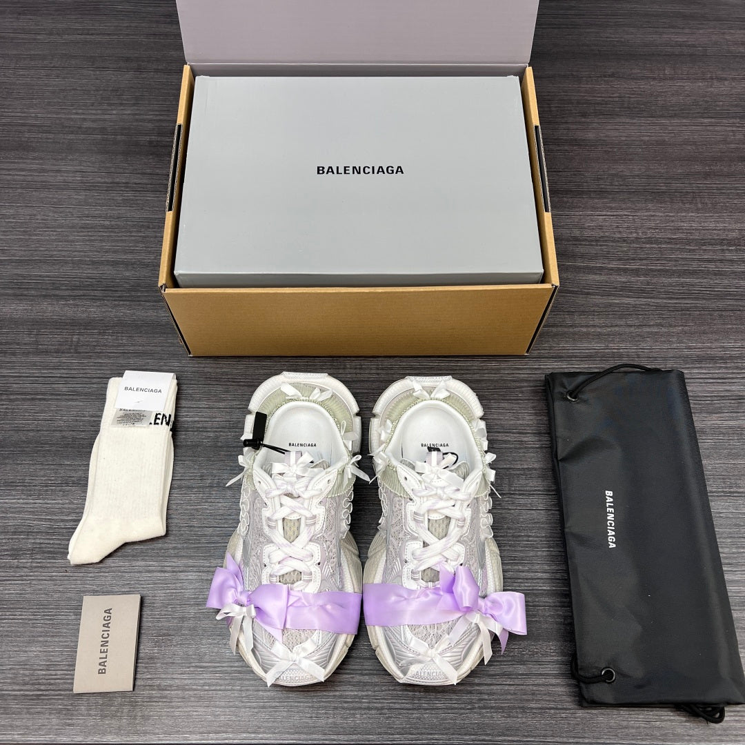 Balenciaga sandals pair in white with lilac ribbon bows and lace-up straps