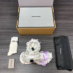 Balenciaga sandals in white with lilac ribbon bows, one shoe with laces and straps