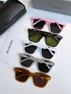 Balenciaga sunglasses set: pink, green, white, and orange frames with dark lenses.