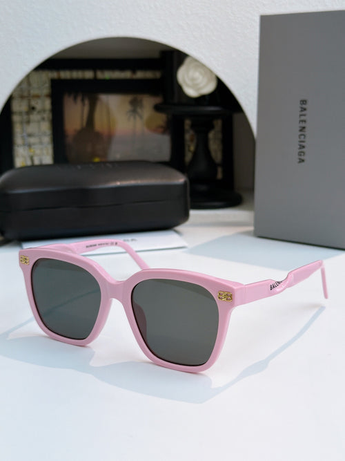 Balenciaga sunglasses with pink frames and dark lenses, square cat-eye style.