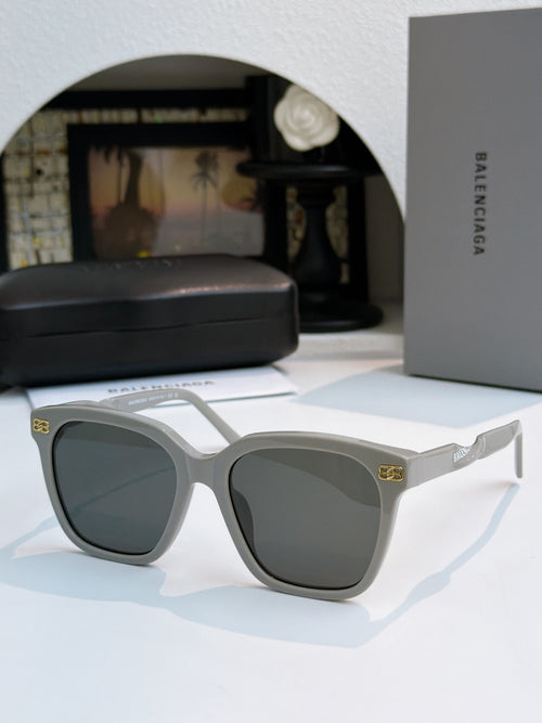 Balenciaga sunglasses with white frames and dark lenses, square cat-eye style.