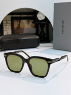 Balenciaga sunglasses with dark tortoiseshell frames and green-tinted lenses, square style.