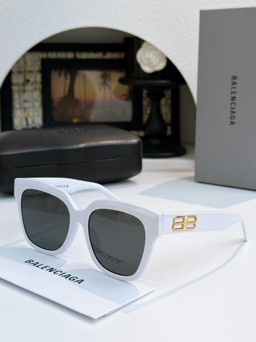 White sunglasses with gold emblem on temple and dark lenses