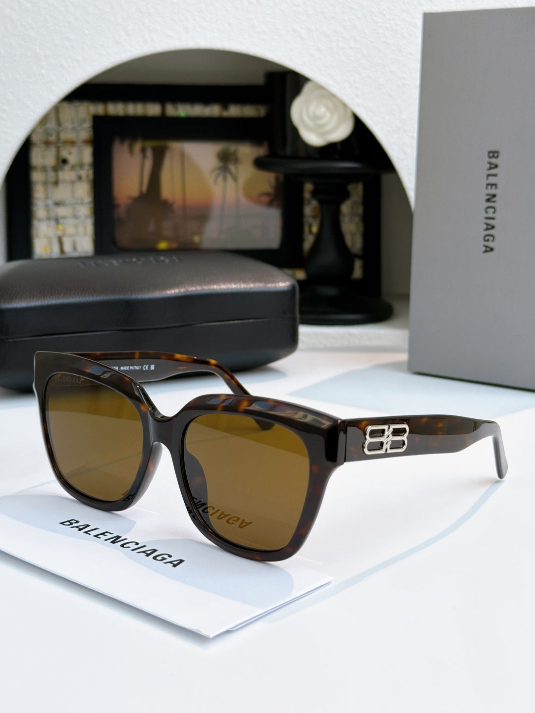 Tortoise sunglasses with gold emblem on temple and amber lenses