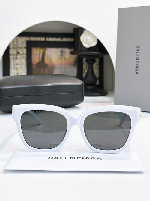 White cat-eye sunglasses with gray lenses and logo accents