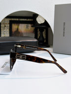Tortoise sunglasses side view with gold logo detail
