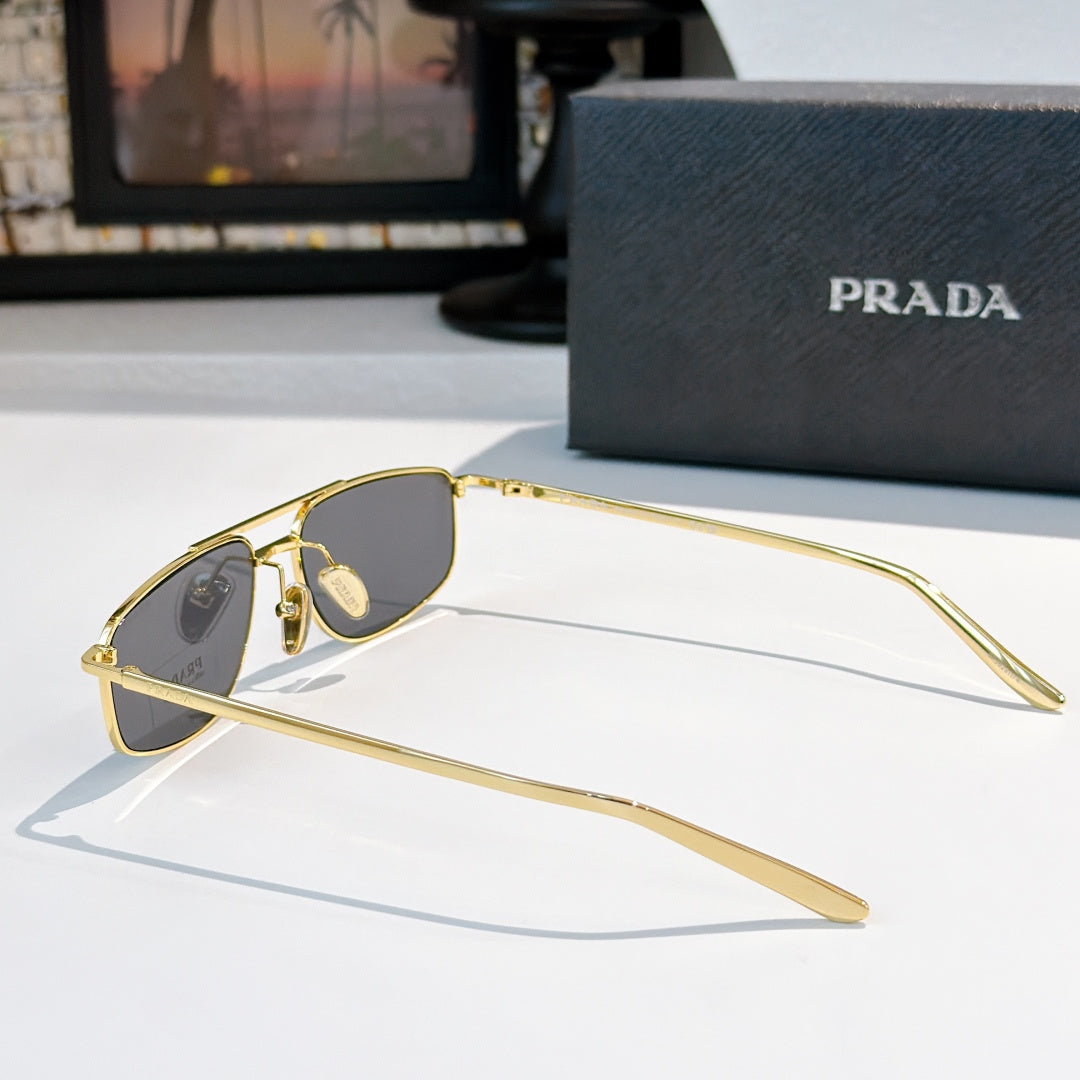 Prada sunglasses side view with gray lenses and gold-tone frame