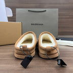 Tan suede mules with beige lining and black drawstring pull tabs