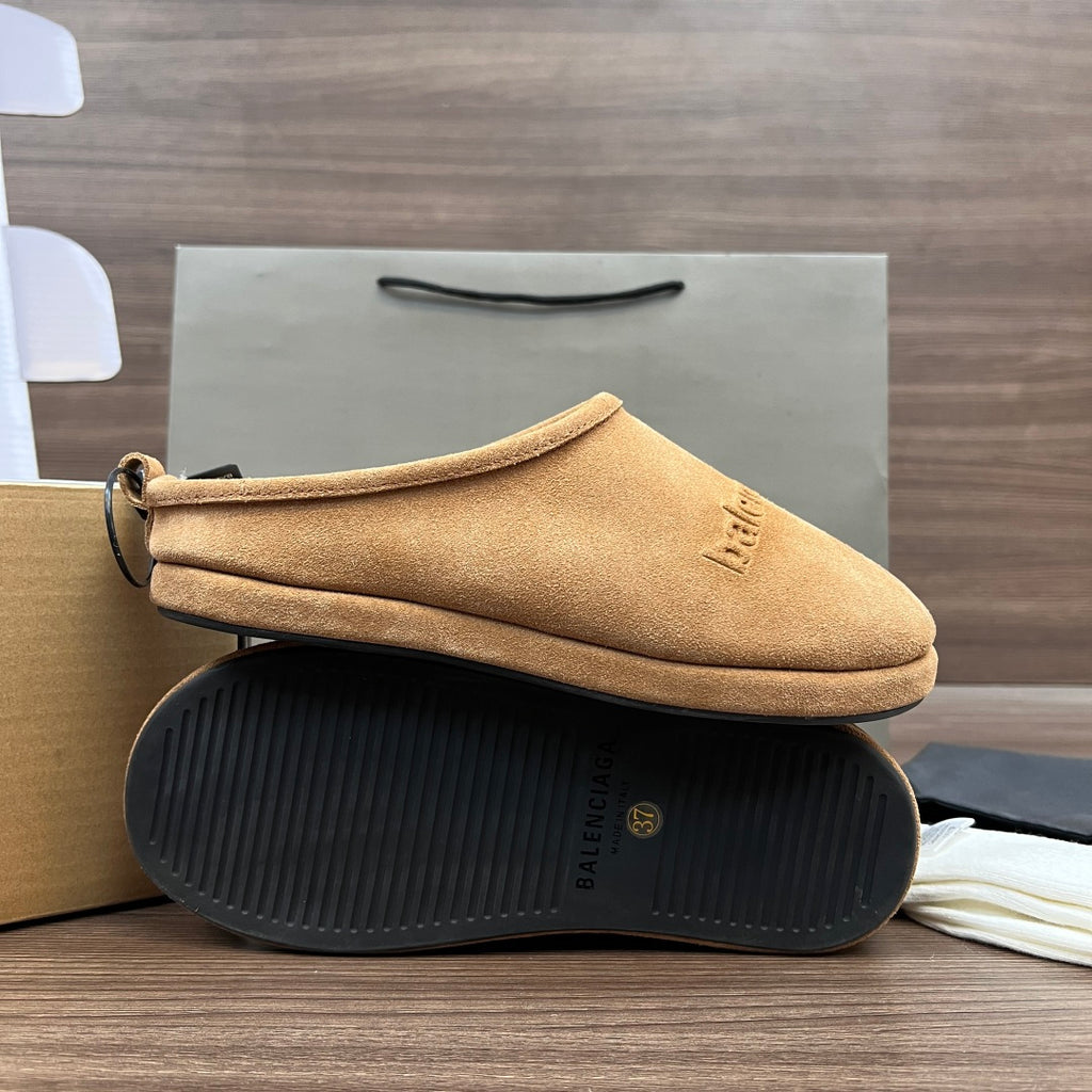 Tan suede sandal with textured black rubber sole and small logo stamp