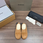 Tan suede sandals with beige lining and black drawstring tags