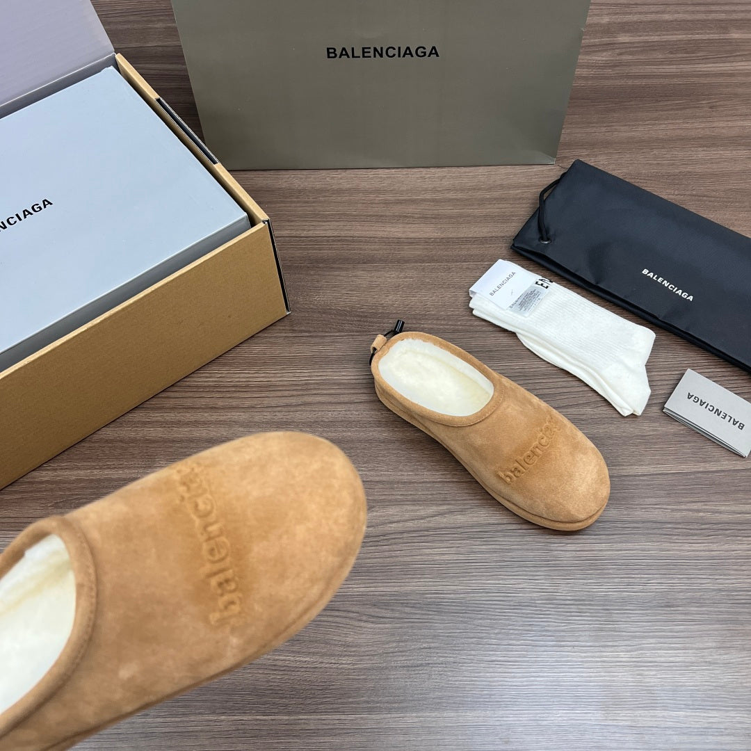 Tan suede slipper-style sandals with rounded toe and beige inner lining