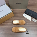 Tan suede sandal pair, one lying sideways with light cushioned insole