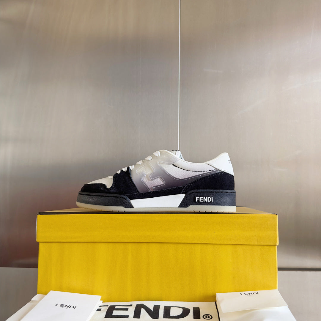 Low-top sneakers on top of a yellow box: white upper with black side panels, lace-up