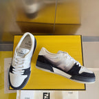 Low-top sneakers with white uppers, black and gray side panels, lace-up style