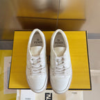 Fendi unisex sneakers, pair front view in box, white leather lace-up with FENDI logos.