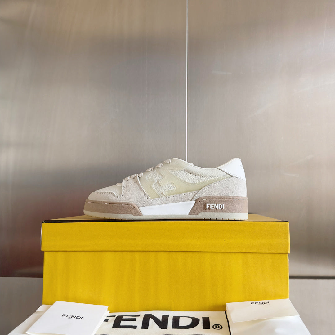 Fendi unisex sneakers on box, white and beige leather lace-up with FENDI logo.