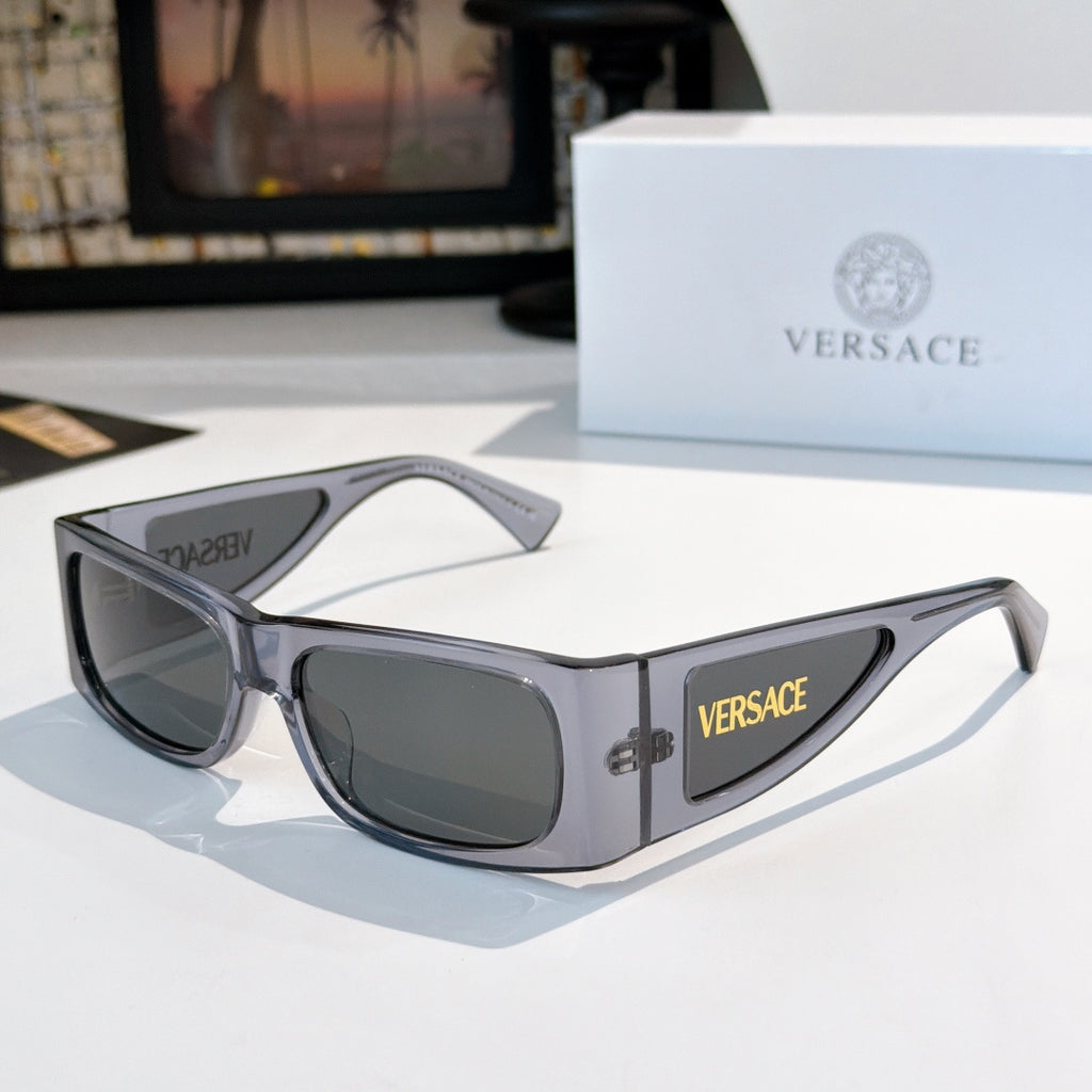 Versace sunglasses with light gray frame and dark lenses, side Versace logo.