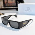 Versace sunglasses with black frame and dark lenses, temple logo detail.