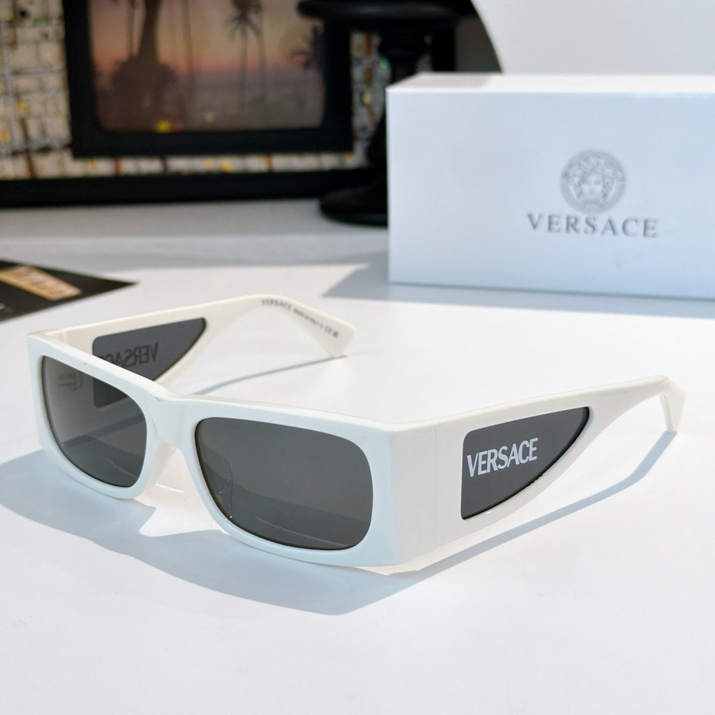 Versace sunglasses with white frame and dark lenses, side Versace logo panel.