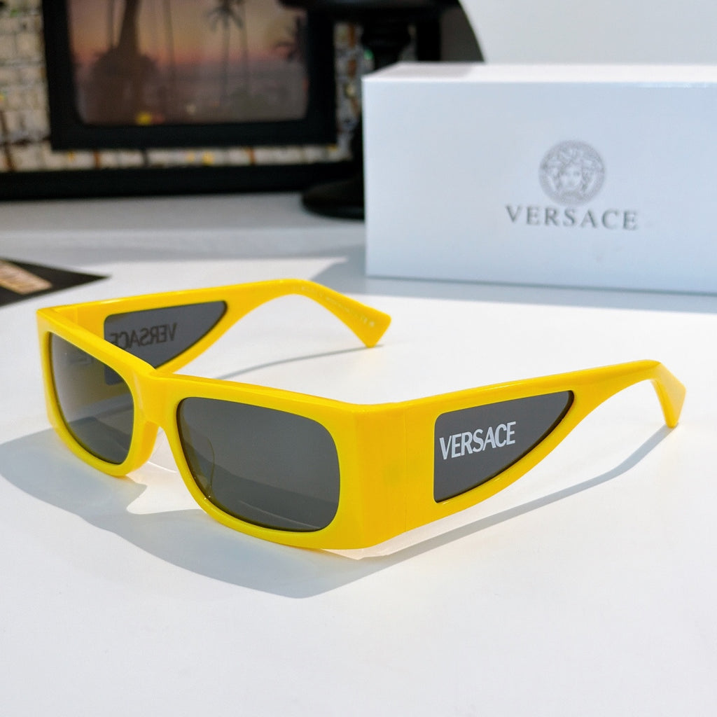 Versace sunglasses with bright yellow frame and dark lenses, side Versace logo.
