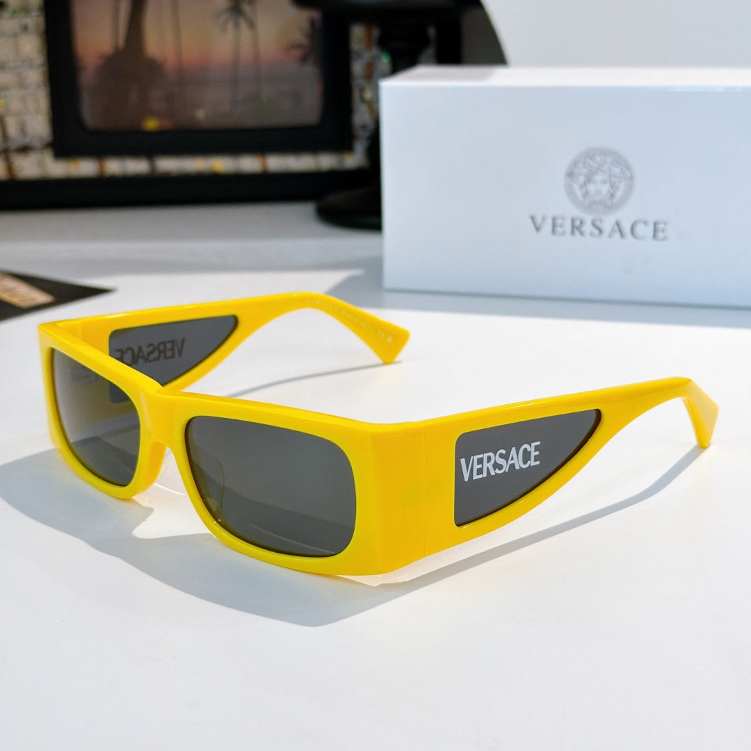 Versace sunglasses with bright yellow frame and dark lenses, side Versace logo.