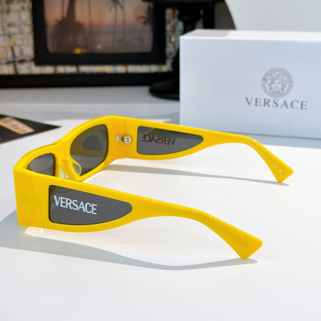 Versace sunglasses with bright yellow frame, side temple detail and Versace logo.