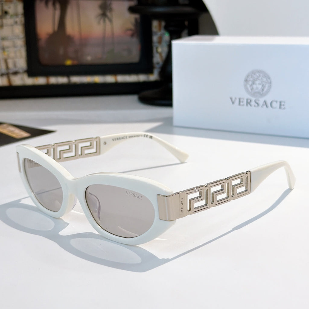 Versace cat-eye sunglasses with white frame, gold Greek key temples, and gray lenses