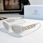 Versace cat-eye sunglasses with white frame, gold Greek key temples, and gray lenses