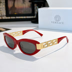 Versace cat-eye sunglasses with red frame, gold Greek key temples, and dark tinted lenses