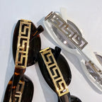 Versace sunglasses temples with bold gold Greek key detailing on black frames