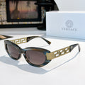 Versace cat-eye sunglasses with dark frames, gold logo temples, and tinted lenses