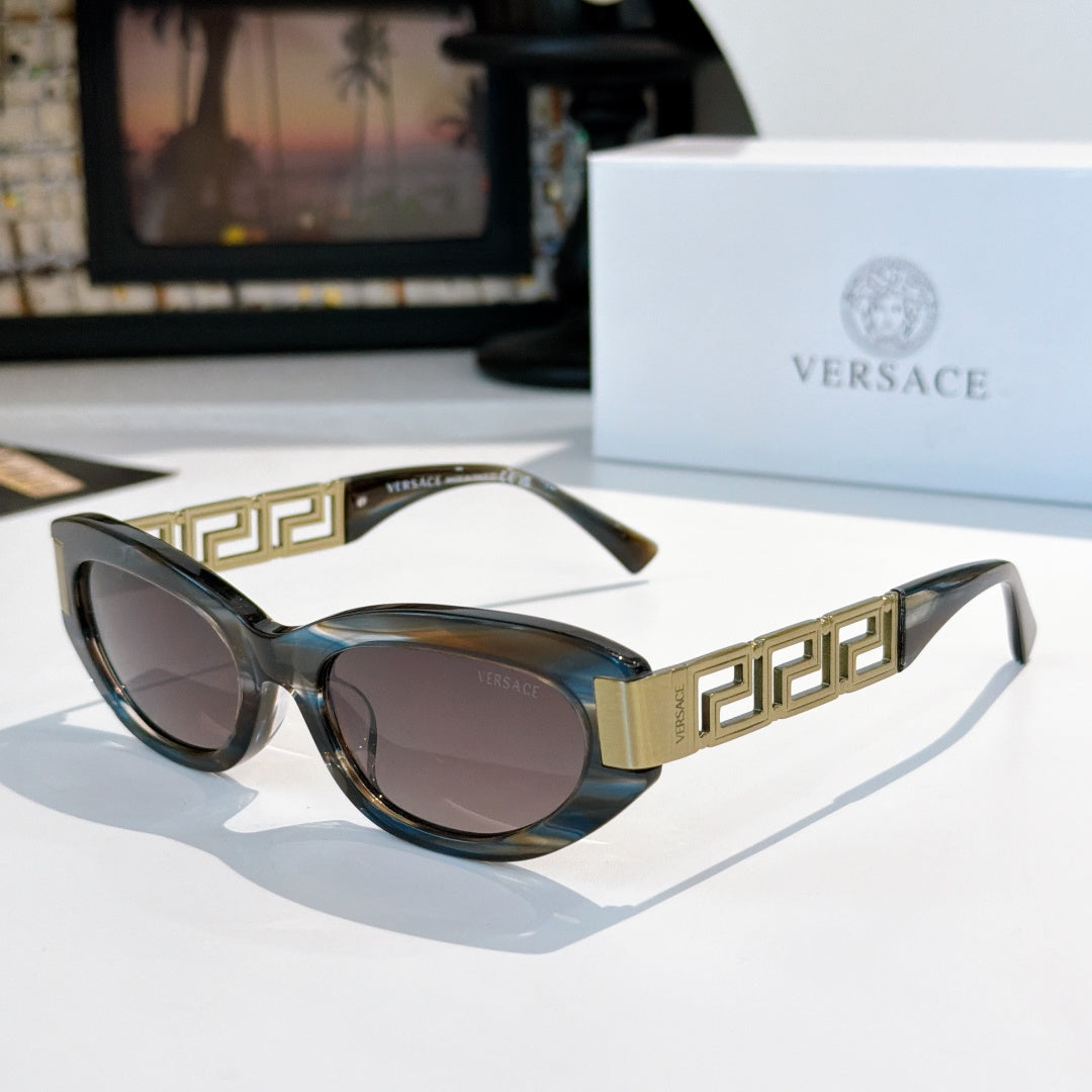 Versace cat-eye sunglasses with dark frames, gold logo temples, and tinted lenses