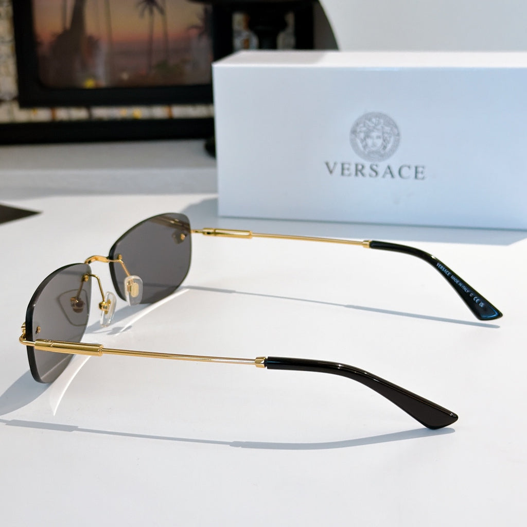 Sunglasses side view with gold metal frame and dark lenses