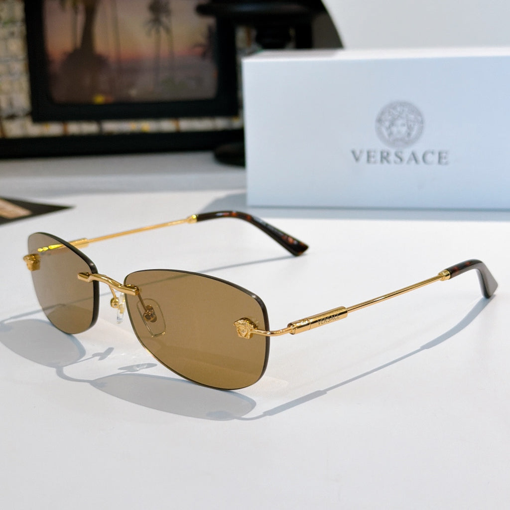 Sunglasses with gold metal frame and brown-tinted lenses