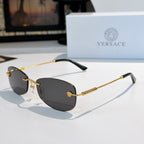 Sunglasses with gold metal frame and dark tinted lenses
