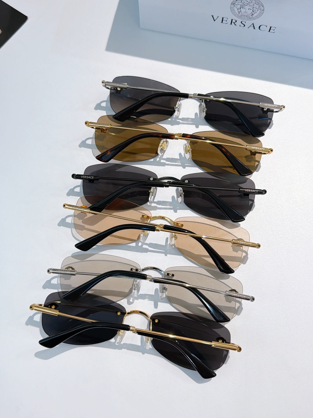 Stack of sunglasses with mixed frames and dark lenses