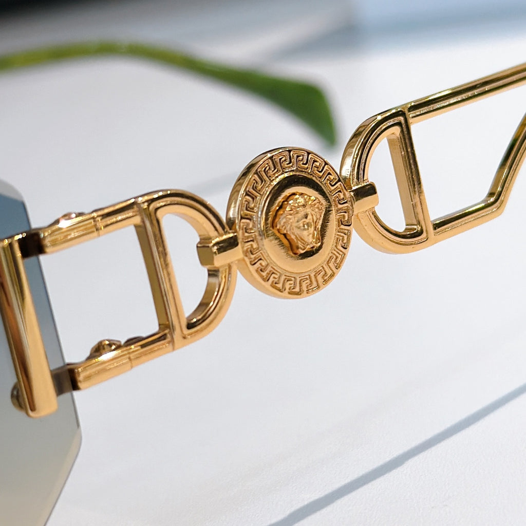 Versace sunglasses close-up of gold-toned logo temple and angular hinges