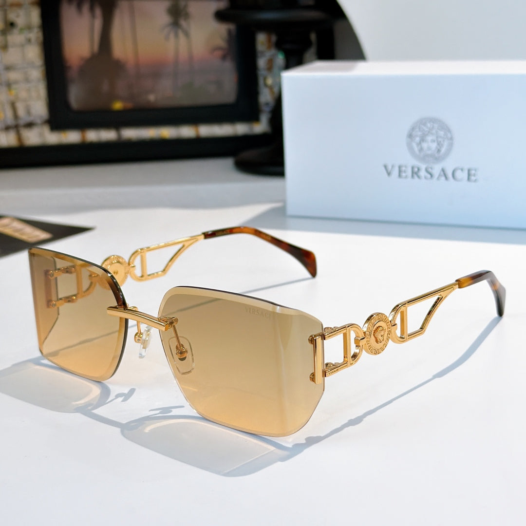 Versace sunglasses with gold-tone frame and warm tan tinted lenses