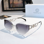 Gold-frame cat-eye sunglasses with slate-gray mirrored lenses.