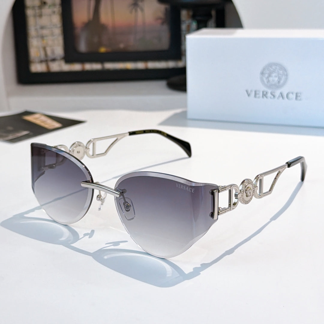 Gold-frame cat-eye sunglasses with slate-gray mirrored lenses.