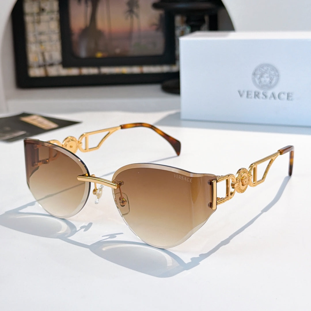 Gold-frame cat-eye sunglasses with tan gradient mirrored lenses.