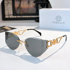 Gold-frame cat-eye sunglasses with dark gray mirrored lenses.